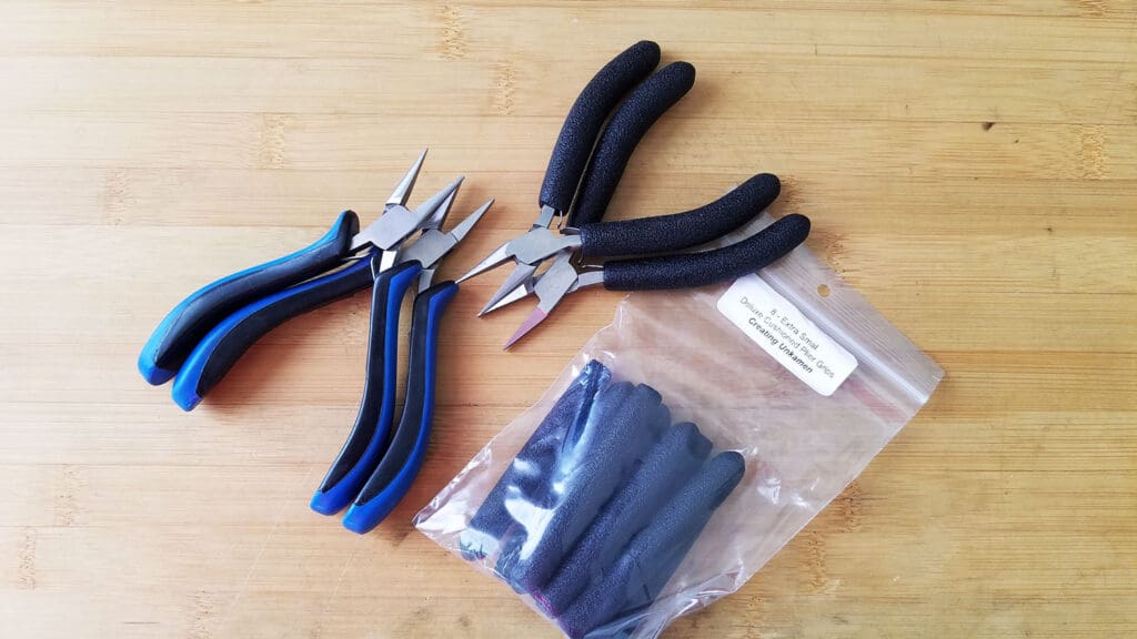 An image of the author's old pliers with the original molded plastic handles and with the replacement comfort grips