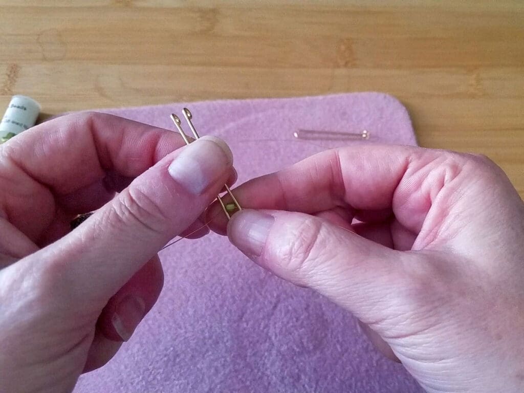 Preparing to anchor the first bead on an easy modern stick earring frame