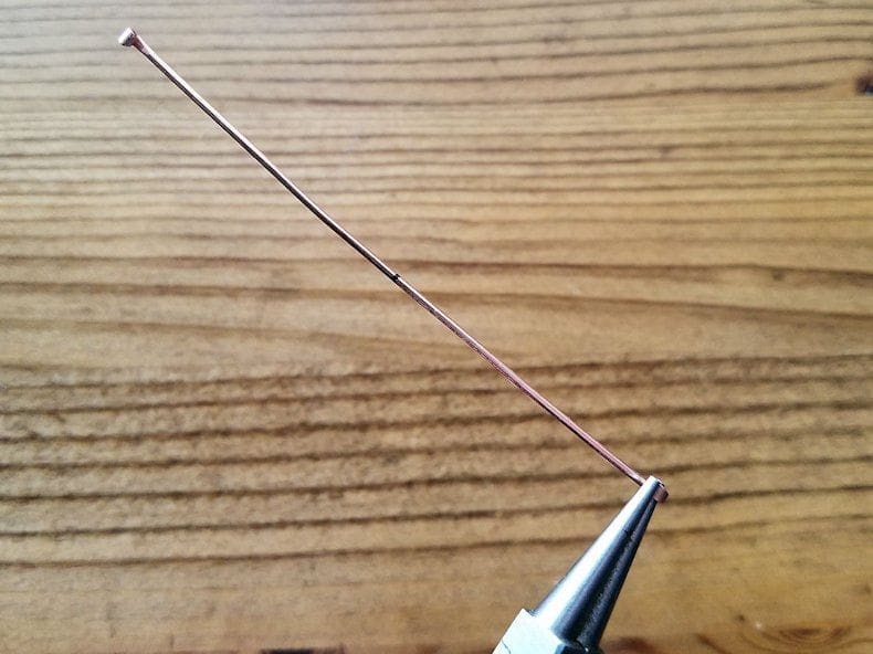 Core Wires Step 7 - Use the tips of your round nose pliers to curl the paddled ends of one 18ga core wire, as shown.