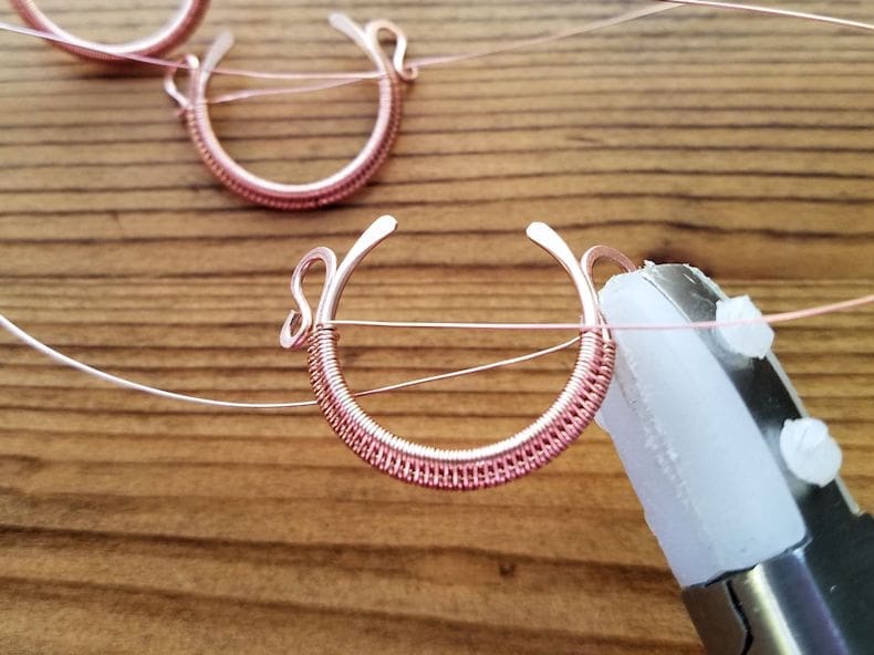 Weaving Step 3 - Sculpt the bead frames into a convex shape and gently bend the curled ends of the outer core wires back, as shown. 
