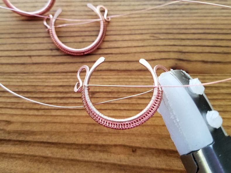 Weaving Step 3 - Sculpt the bead frames into a convex shape and gently bend the curled ends of the outer core wires back, as shown.