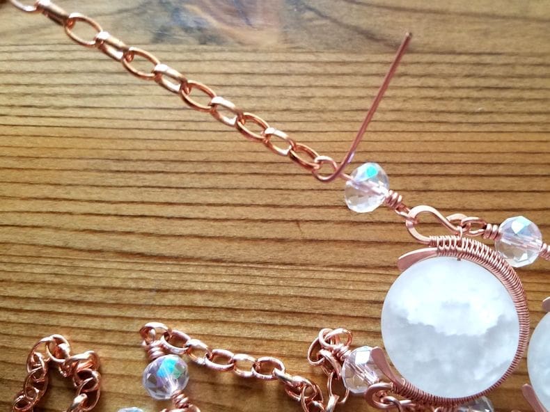 Chain Step 8 - Attach the remaining loose chain to the top of the single beaded connector on the other side of the pendant, as shown.