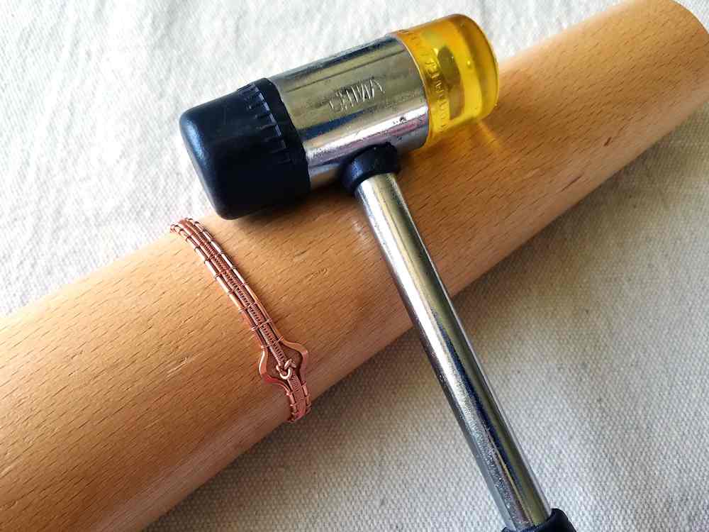 Step 36 - Form your bracelet into its final shape. Use of a bracelet mandrel and soft mallet, as pictured, is optional.