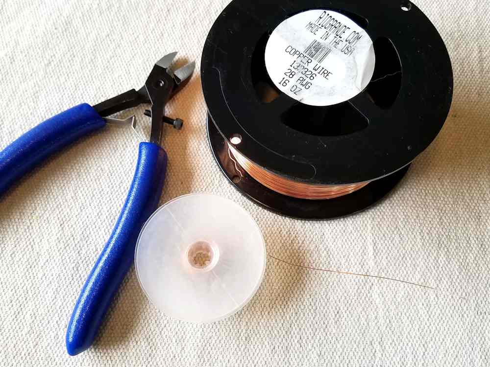 Step 19 - Cut a piece of 28ga dead soft weaving wire to the length specified. Alternatively, wrap several feet of 28ga wire on a plastic Kumihimo bobbin, as shown.