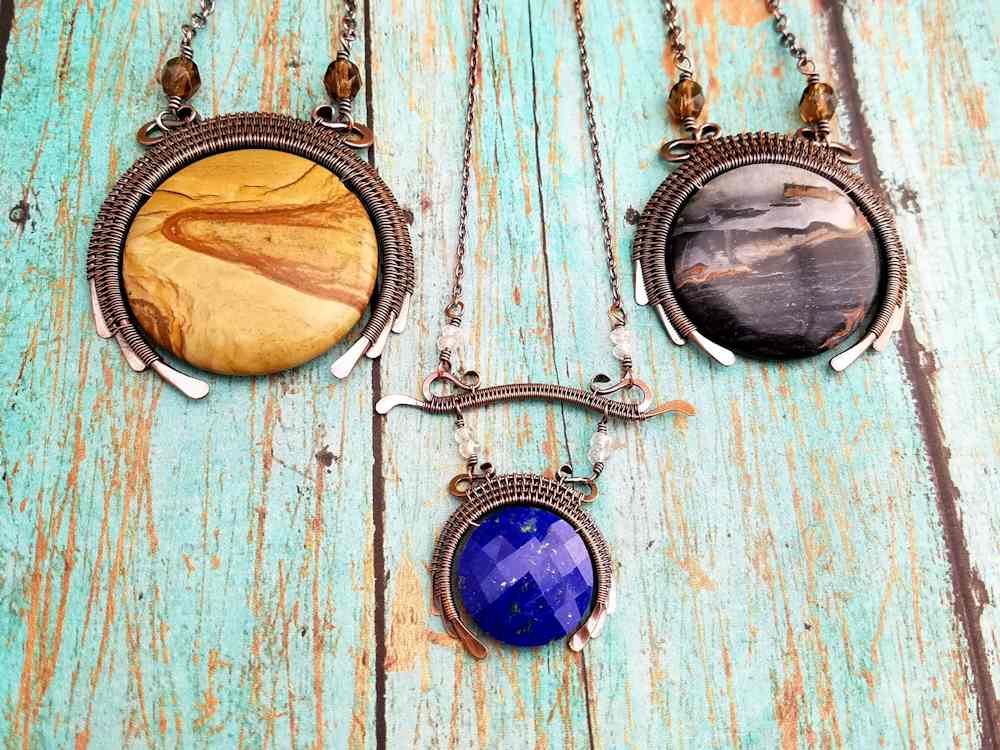 Pictured here are three basic variations of the New Moon Pendant. The pendant on the left features a 35mm Picture Jasper gemstone bead. On the right is the pendant that I created while writing this tutorial. This is a 30mm Agate bead. Finally, the delicate Blue Lapis New Moon pendant (center) was suspended from my Delicate Bar Pendant. This is one example of the countless ways that Door 44's wire woven components can be combined to create pieces that are uniquely yours. 