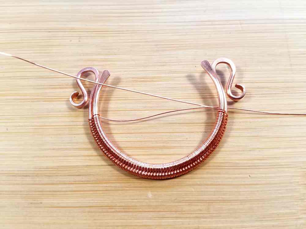 Step 1 - This is an alternate method of suspending the beads within the bead frame. We're picking up from Step 5 of the previous Weaving section where the core wires are partially woven together.