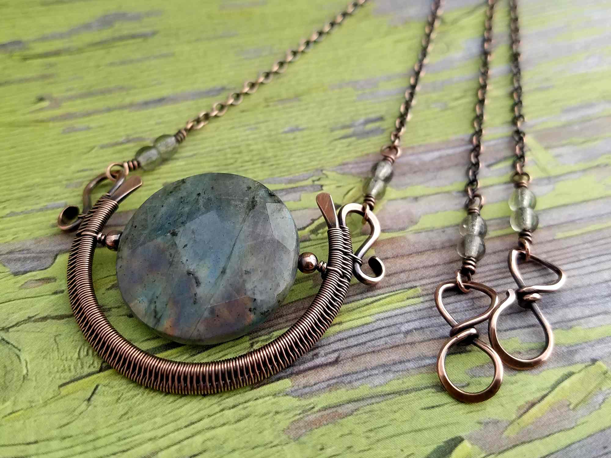 The Egyptian Sun Pendant featuring a faceted Labradorite focal bead and using my alternate method for securely suspending a focal bead within a woven wire frame.
