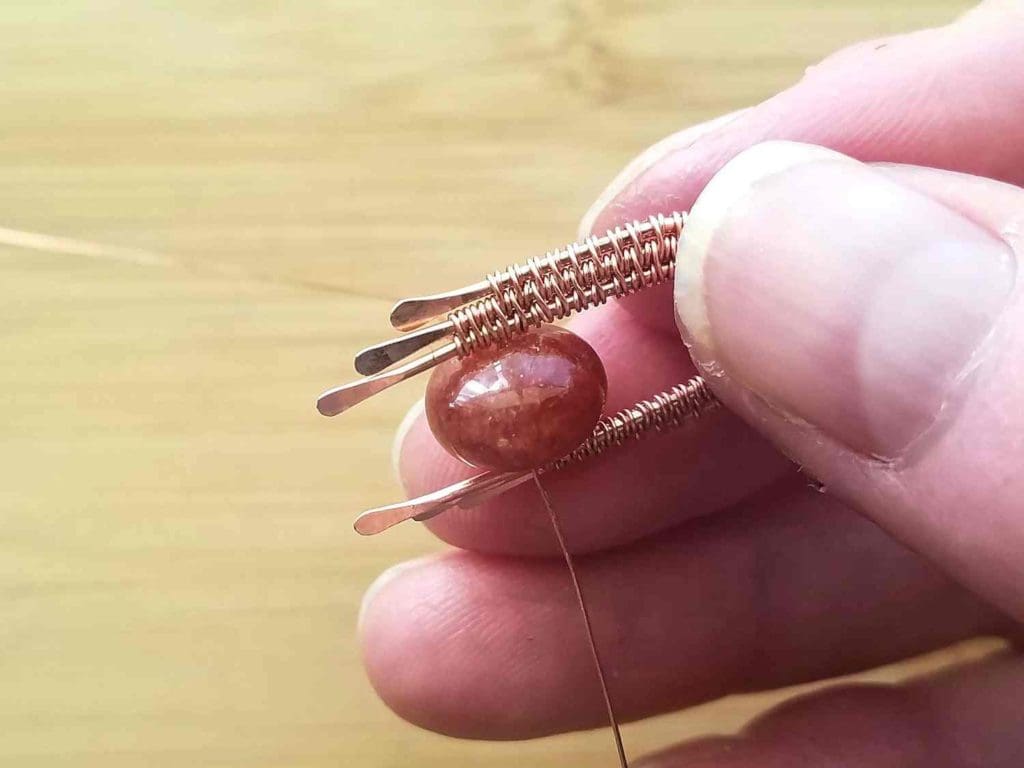 Step 9 - Once the bead is secure, continue weaving in pattern. Reduce the weave to core Wires 1 and 2 when you reach the top of the paddled end on Wire 3, as shown. 