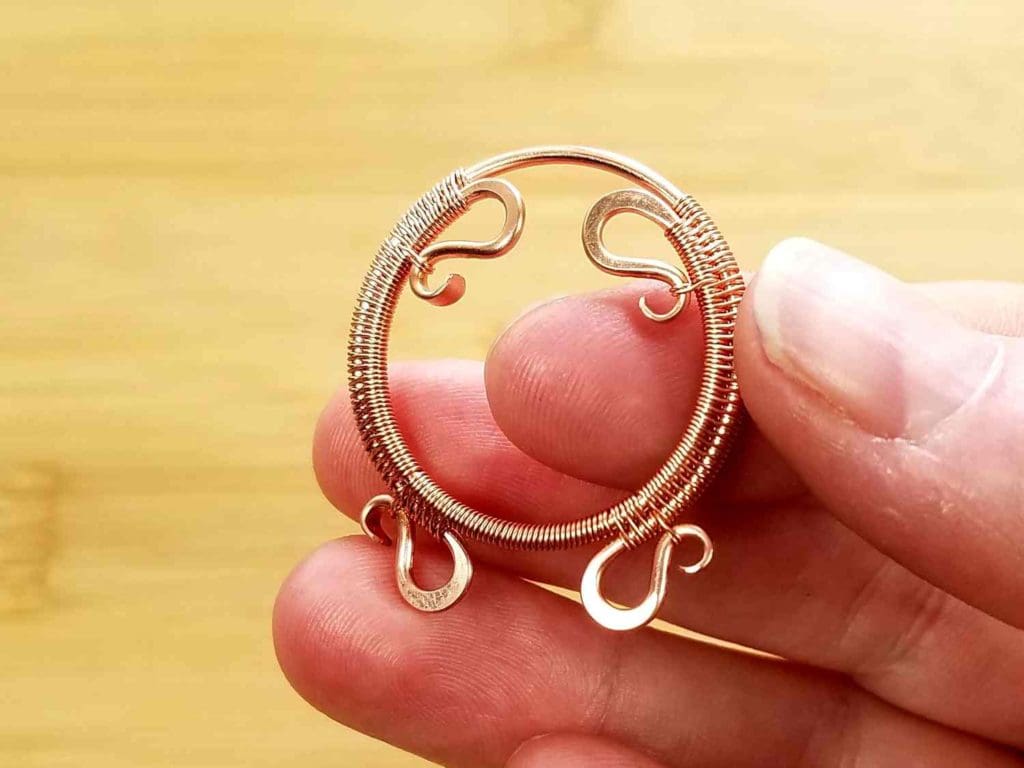 Beads Step 1 - Form the woven core wires of your Rosewood Pendant into a convex curve by pushing Wire 1 forward and Wire 2 back with your fingers, as shown.