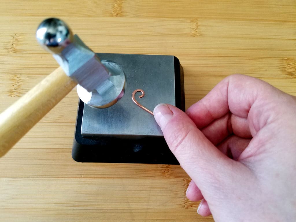 I've now rotated the wire about 180 degree from where I started to finish hammering the curl, as shown.