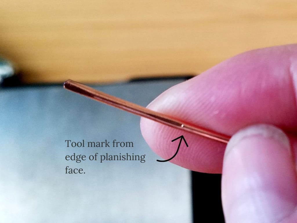 A closeup view of a tool mark created by the edge of the planishing head