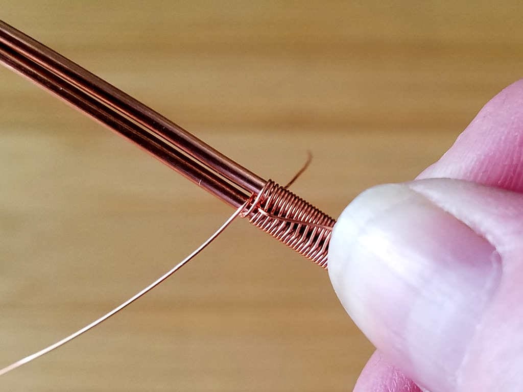 Step 3 - Once you have your new weaving wire in position, begin weaving the pattern exactly where you left off. In this image, you can see that I started the new weave with a double pass across both core wires as shown. This continues the pattern seamlessly as I left off with the single pass on the old weaving wire.