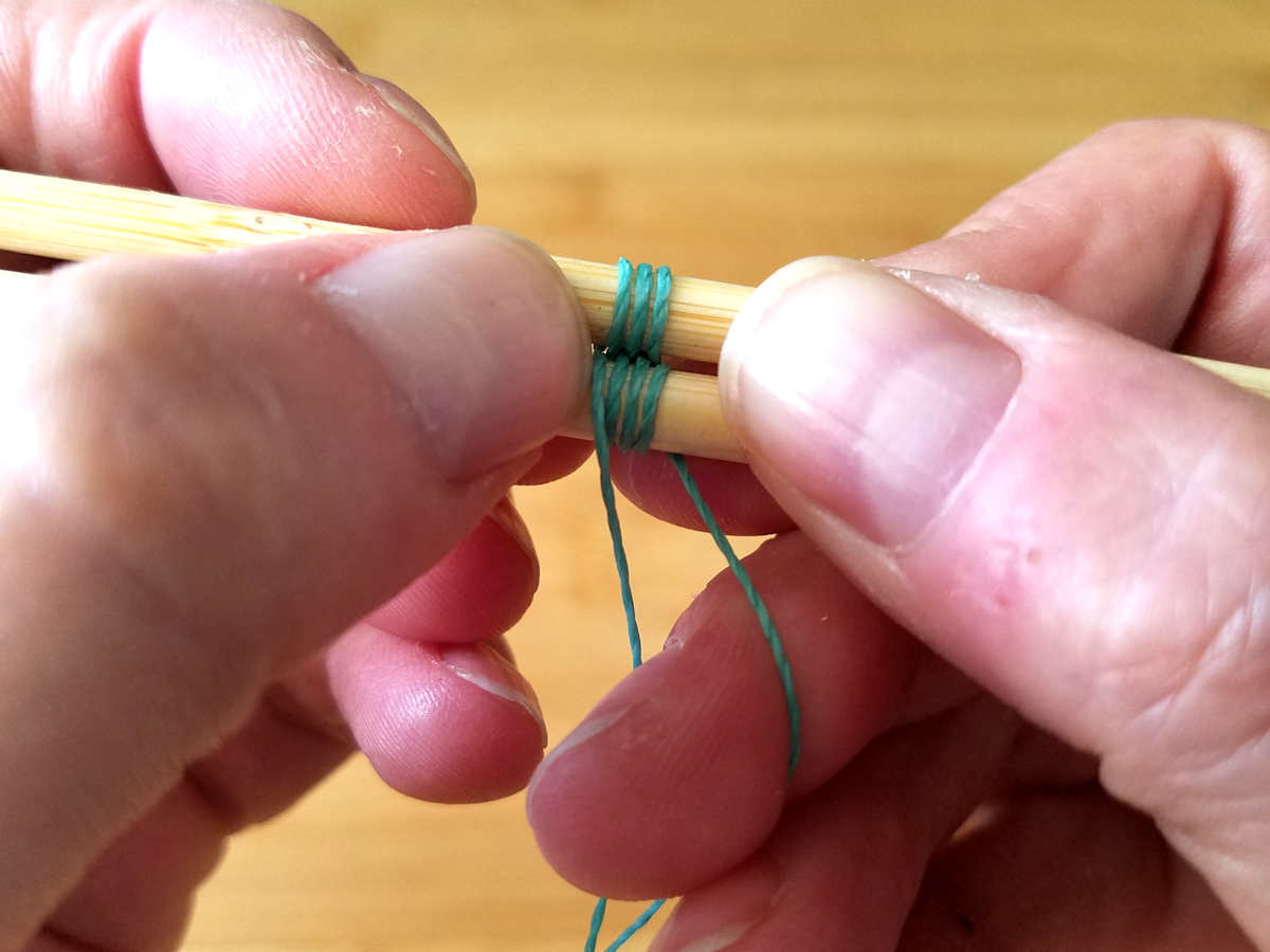 Compressing the weave regularly is an important step toward achieving a neat and tidy weave. Here, I'm compressing the weave by gently nudging the wraps together with my thumb nail