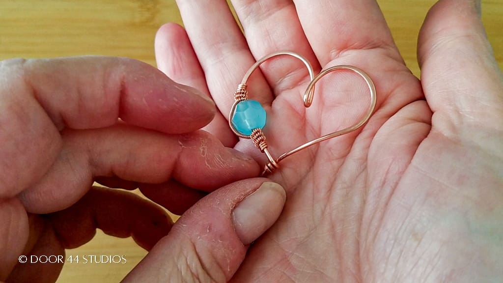 The finished quick and easy wire heart pendant after securing completing the coiled coil and the final shaping of the pendant