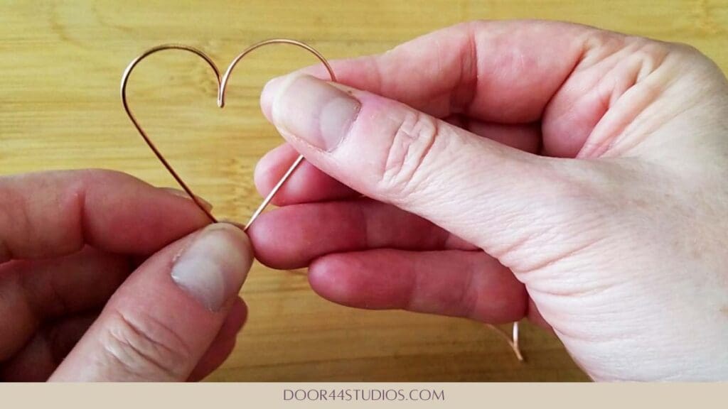 The finished heart shape of one simple heart hoop earring