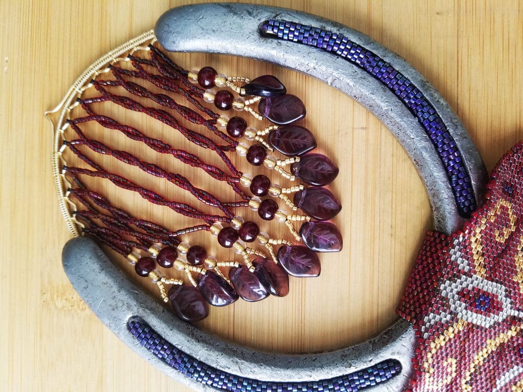 Detail of the wire woven horseshoe hanger with beaded fringe